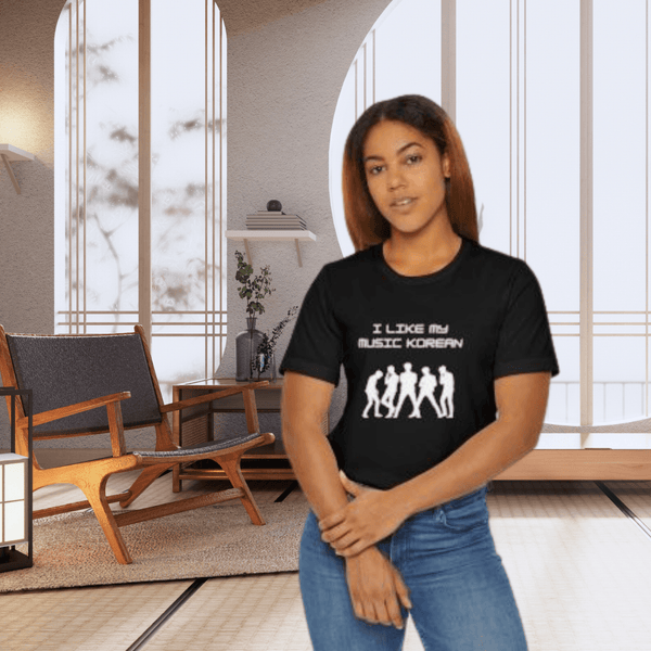 Person wearing a black t-shirt with white text and graphics in a modern room.