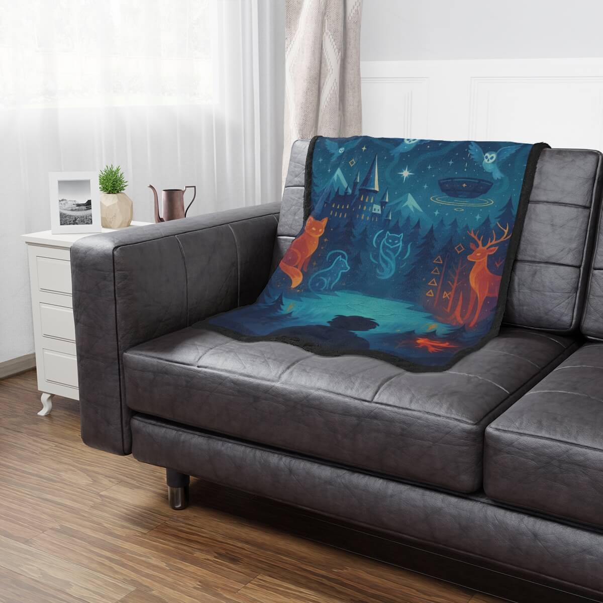 Decorative blanket with fantasy design on a gray sofa in a living room.